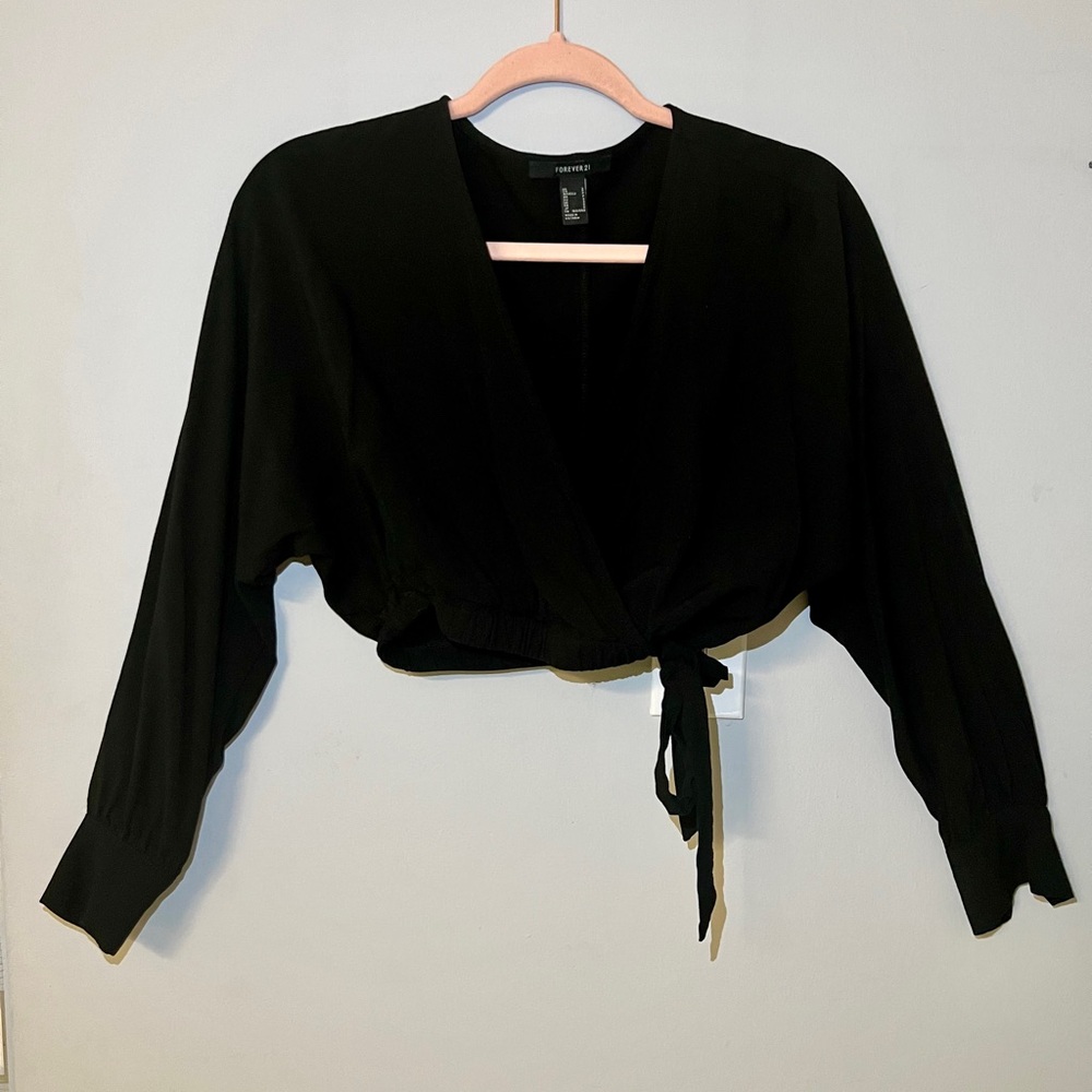 Black long sleeve blouse, cropped and has a V cut.